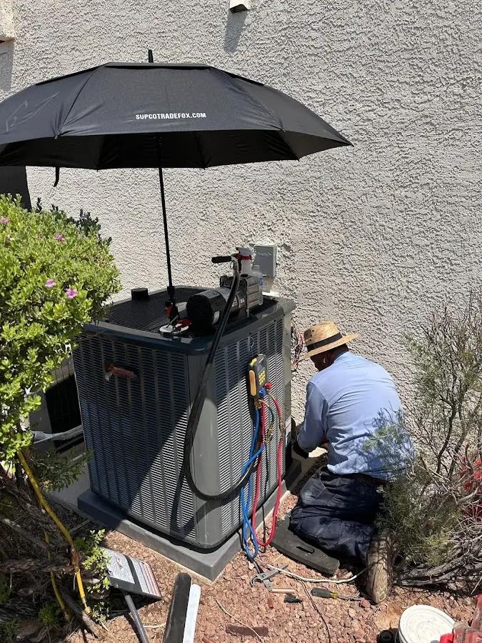 HVAC technician performing outdoor AC maintenance in Northville